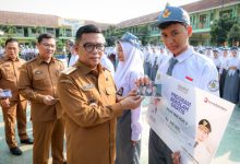 Andra Soni, Gubernur Banten menyerahkan biaya prorgam sekolah gratis ke siswa SMK PGR 3 Kota Serang. Foto: Biro Adpim Banten