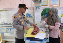 Kapolres Serang, AKBP Candra Sasong menenguk bayi yang ditemukan di pinggir jalan. Foto: YOno