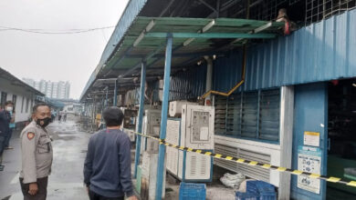 Polisi pasang police line di gedung pres pabrik sepatu yang terbakar. Foto: Yono